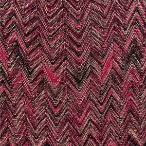 This sweater has gold flecks weaved into it.It’s hard to see but it is stunning